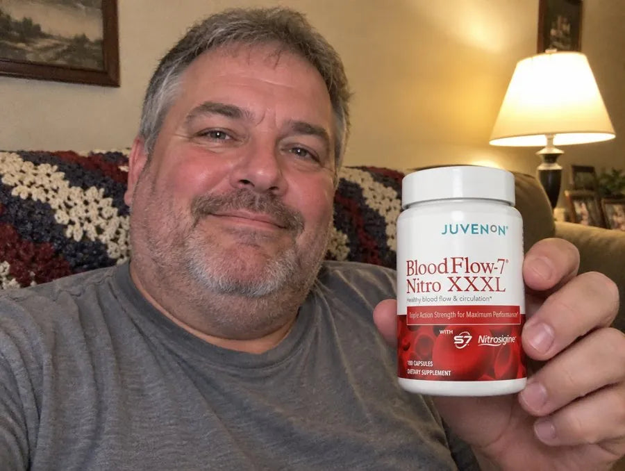Man holding BloodFlow-7 Nitro XXXL on his couch